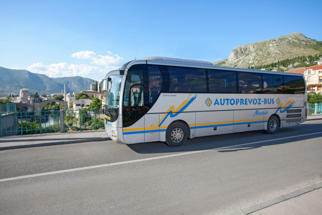 Mostar Old Bridge and one of the buses owned by Autoprevoz-Bus Mostar, company that operates Bus Station Mostar